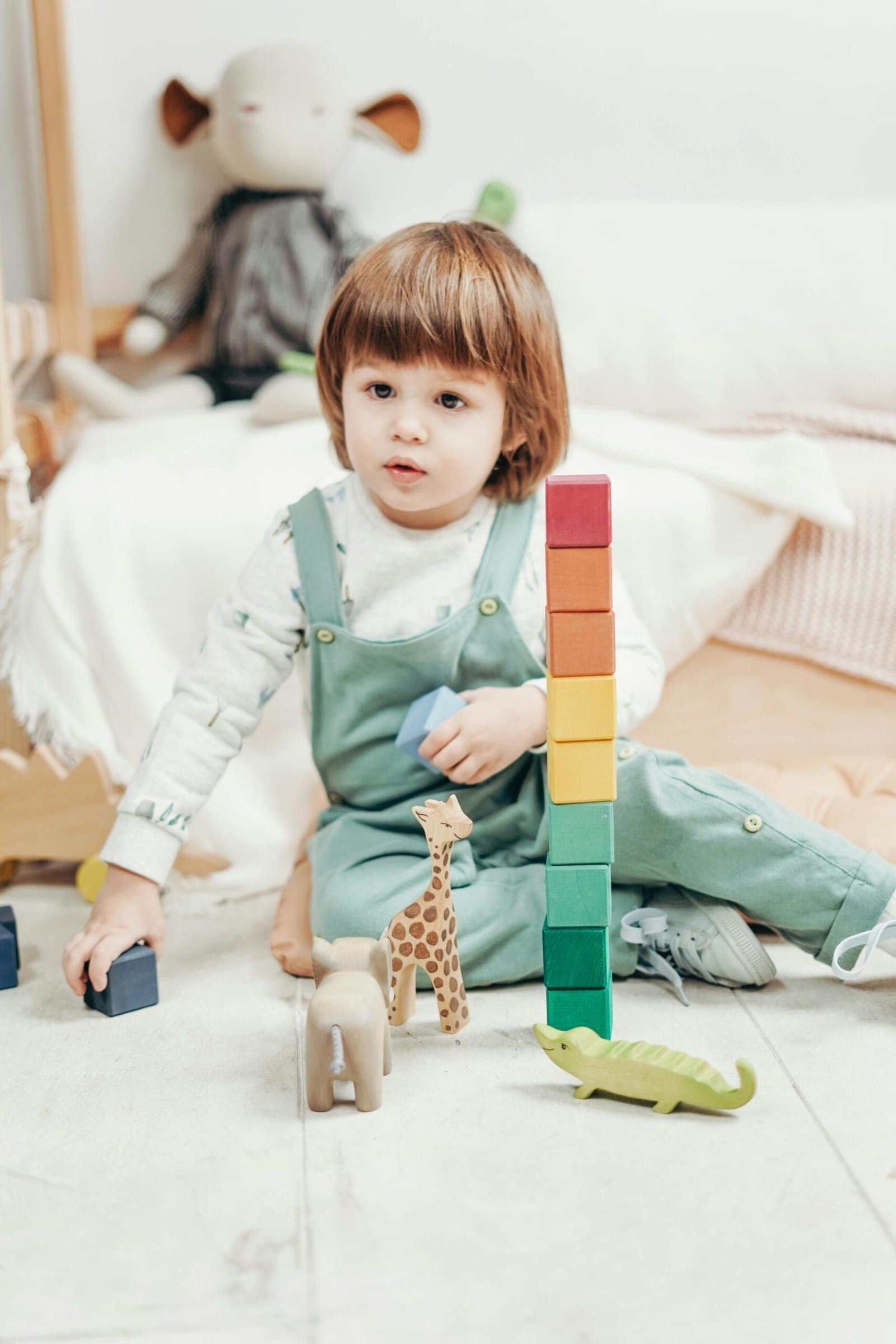 Child playing with wooden educational toys